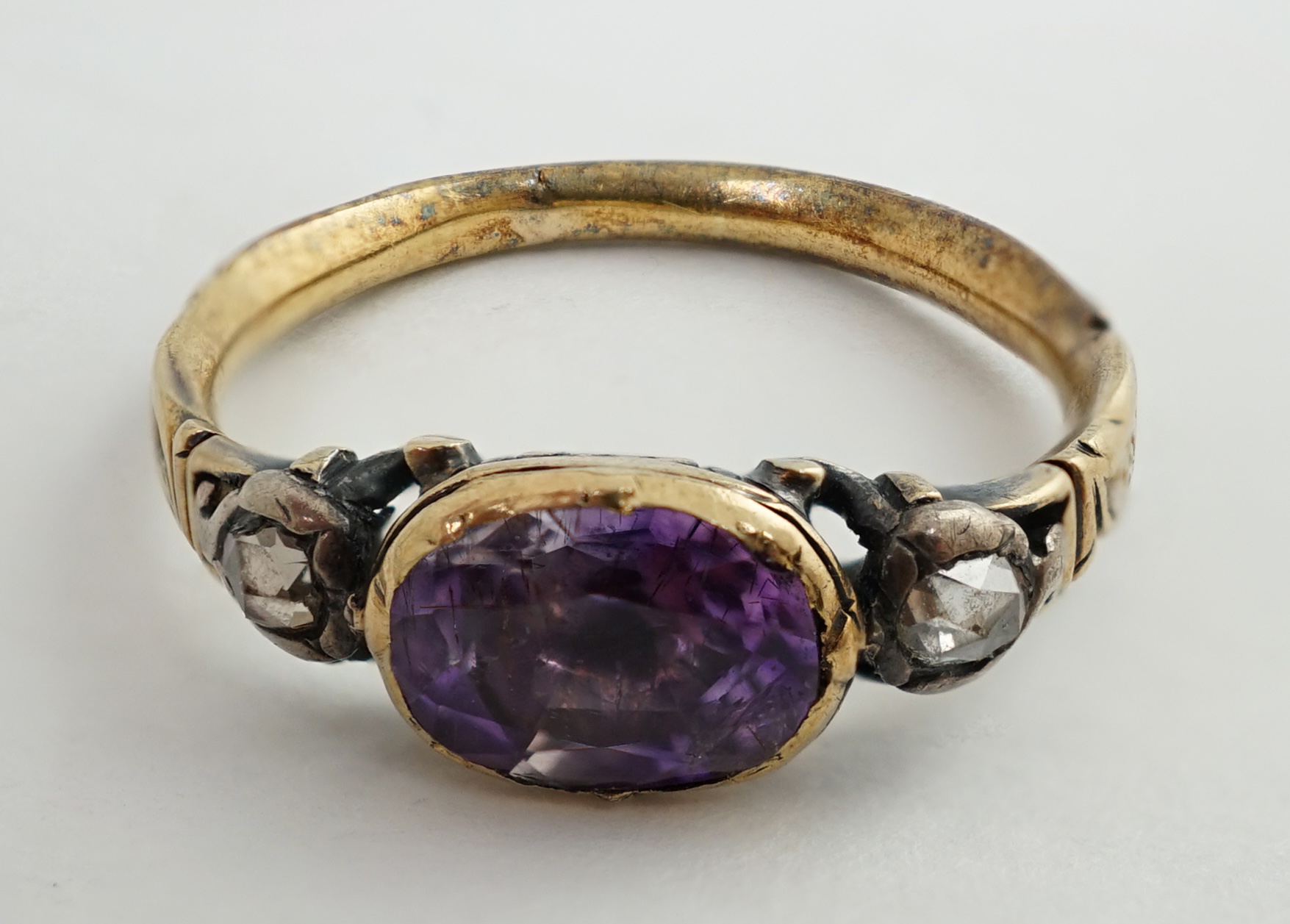 A George III gold, single stone foil backed amethyst and two stone rose cut diamond set memorial ring